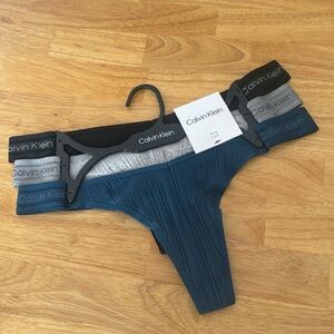 Calvin Klein Thong panties 3 pack new with tags size Medium logo sides rib text